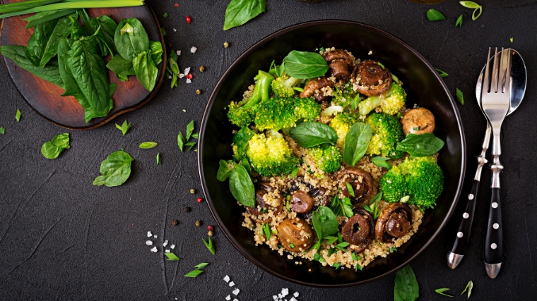 Healthy vegan salad vegetables in a black bowl