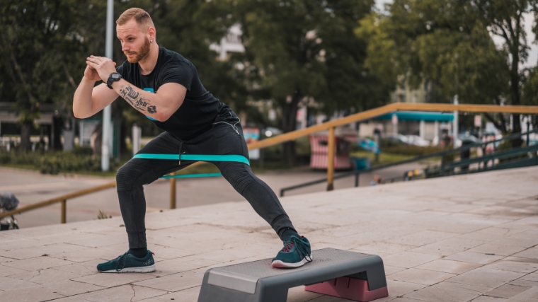Person doing fitness exercises with elastic resistance band