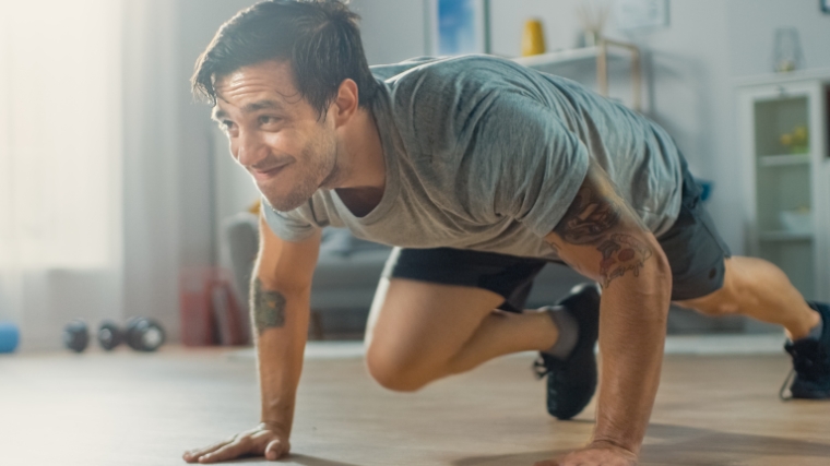 Person in a gray shirt exercising with isometrics