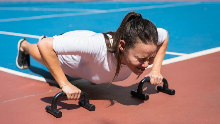 Person straining while doing push ups