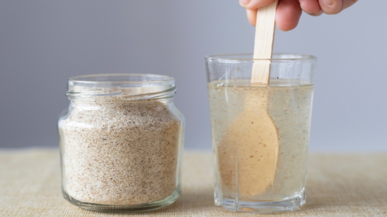 Psyllium husk soluble fiber supplement in a glass of for a healthy gut.