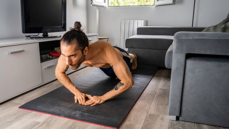 Shirtless person performing a diamond push-up.