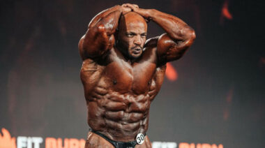 Bodybuilder Big Ramy posing on a bodybuilding stage.