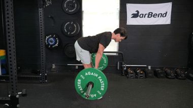 A person performing the romanian deadlift exercise.