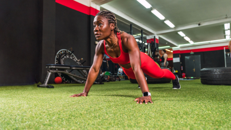 A person performs push-ups in the gym.