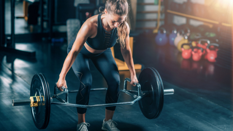 Woman performing a trap bar deadlift