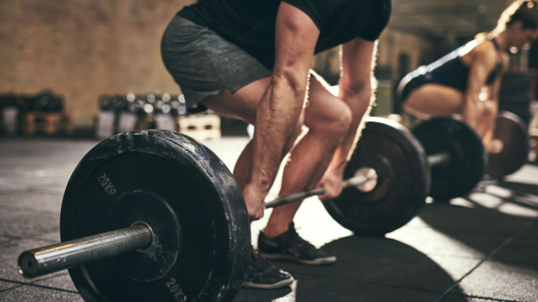 Person setting up to deadlift a barbell