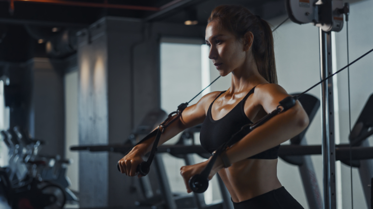 Woman performs high cable chest press