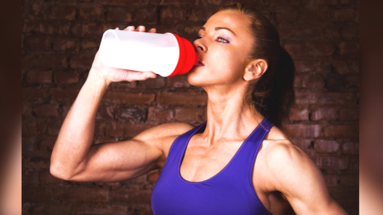 A bobybuilder gulping a protein drink.