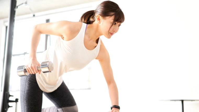 A person doing a single dumbbell row.