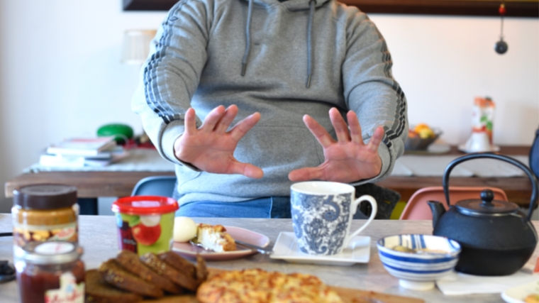 A person in front of a full table of food.