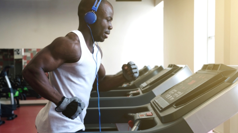 A person jogging on the treadmill in the gym.