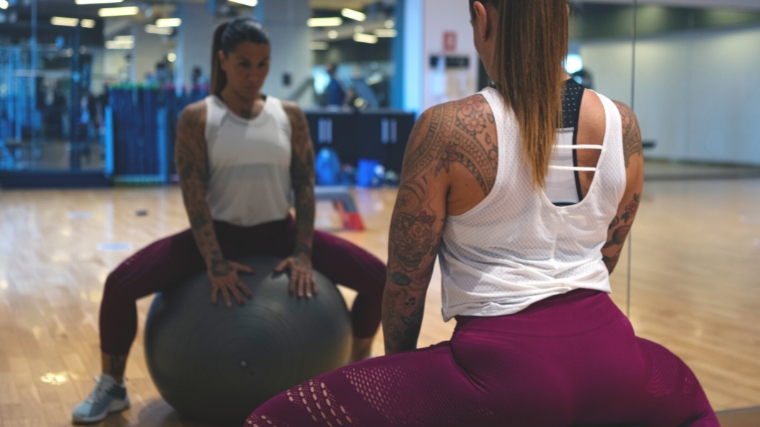 A person using a stability ball to exercise the lower back.