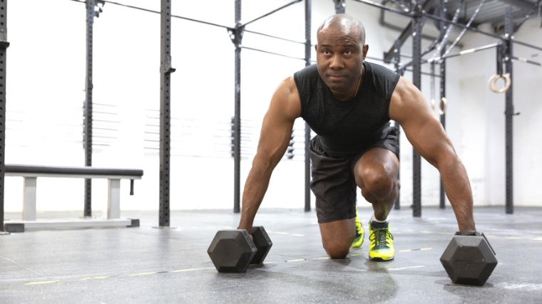  A person working out with dumbbells in the gym.