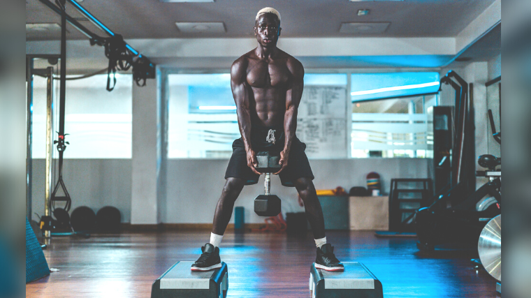 A young bodybuilder working out with a dumbbell.