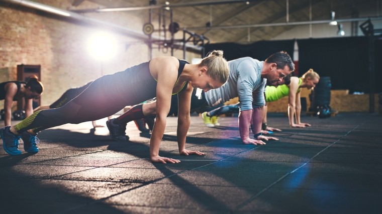 People planking in the gym.