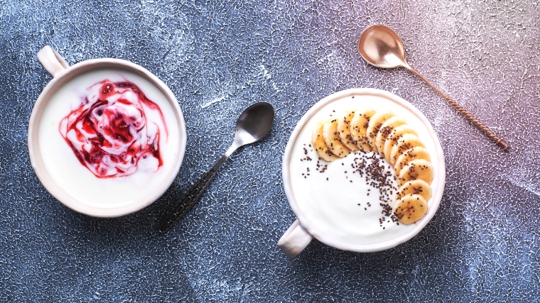 Yogurt in two cups on the table.