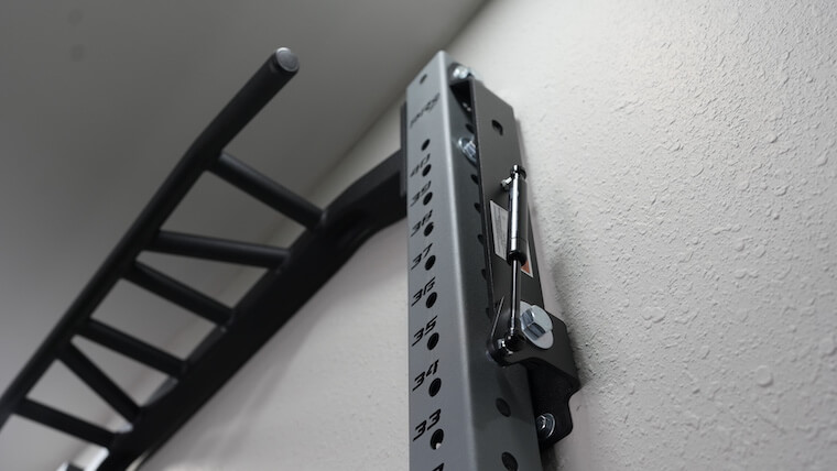 PRX Profile Pro Folding Squat Rack mounted to a wall.