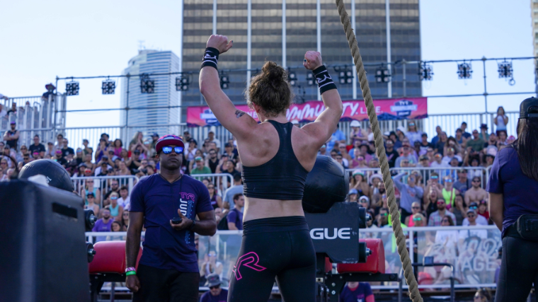 An athlete celebrates an event finish in front of a crowd.
