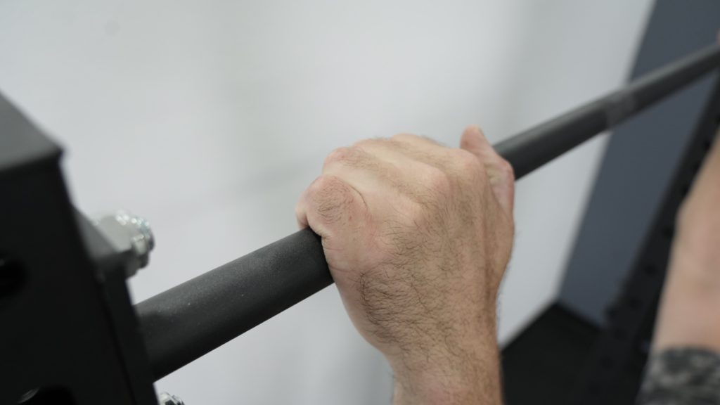 A close-up shot of the pull-up bar on the Fringe Sport Unlimited Squat Stand.