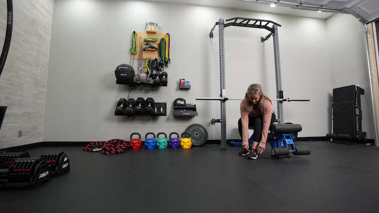 A person preparing to use the PRX Profile Pro Folding Squat Rack.