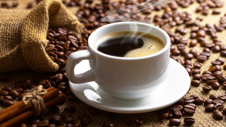 A cup of black coffee sitting on a table. 