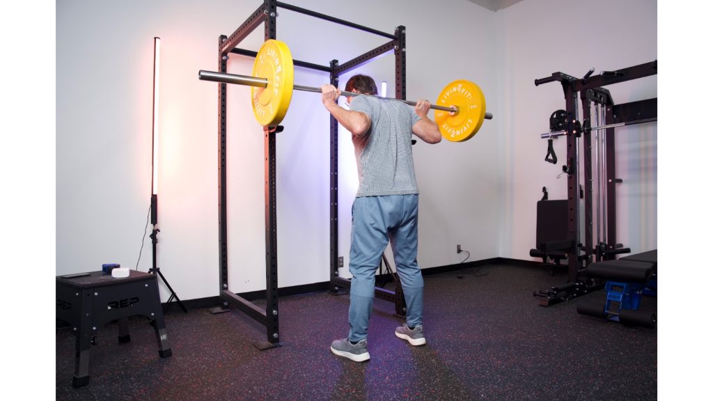 A person using the Titan T3 Squat Cage.