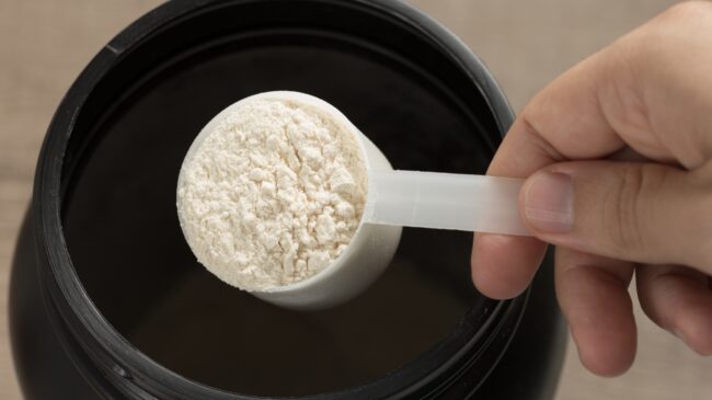 A scoop of powder from a supplement container.
