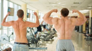 Two bodybuilders checking their form.