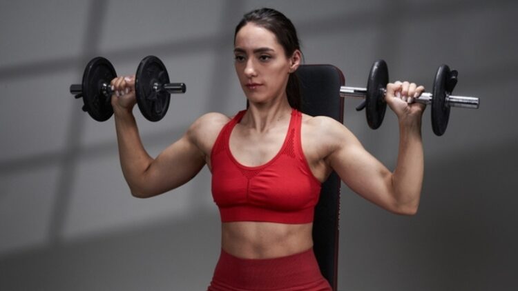 A person doing a shoulder press exercise