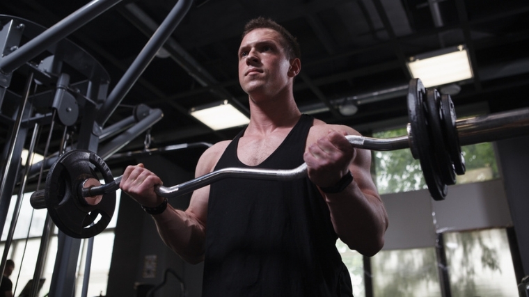 A person doing barbell curls.