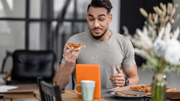 A person having pizza on refeed day.
