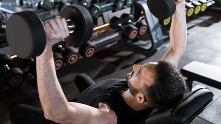 A person performing a dumbbell press.