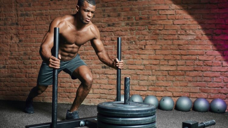 A person performing a sled push.