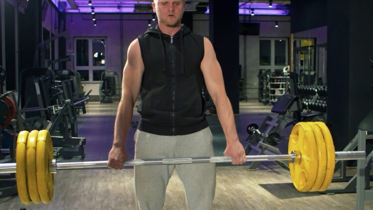 A person performing an axle deadlift.