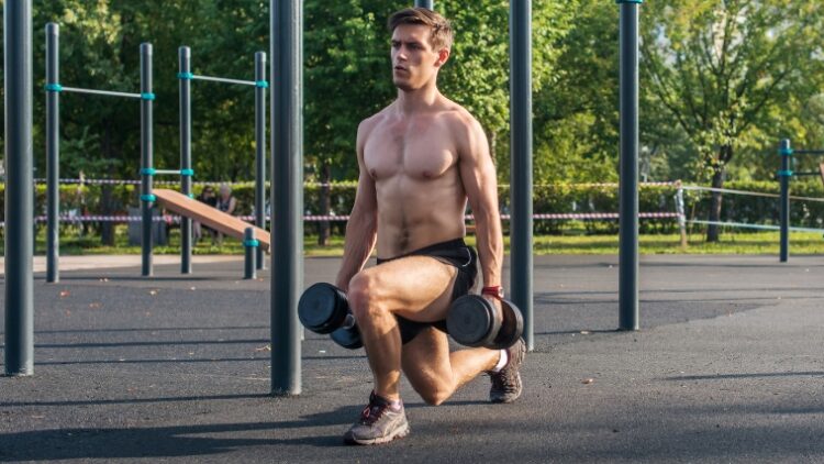A person doing the dumbbell split squat with tension in the arms.