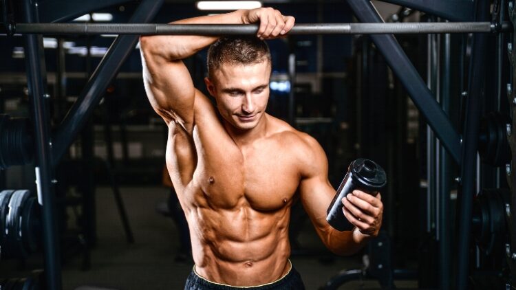 A person holding a drink in the gym.