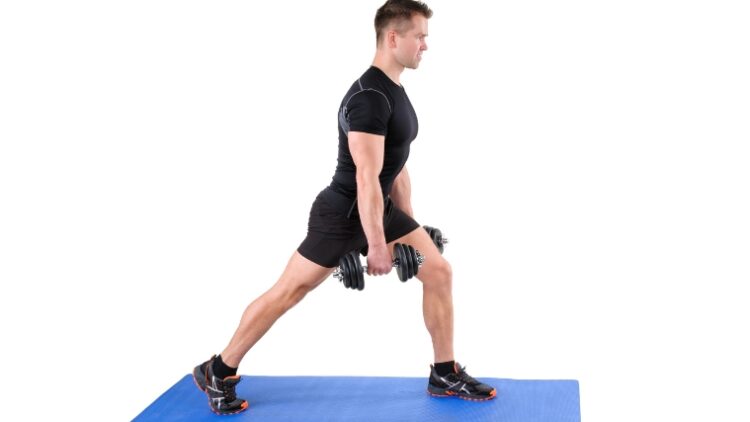 A person in the starting position of the dumbbell split squat.