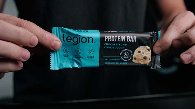 Person showing off the label of Legion High-Protein Bars