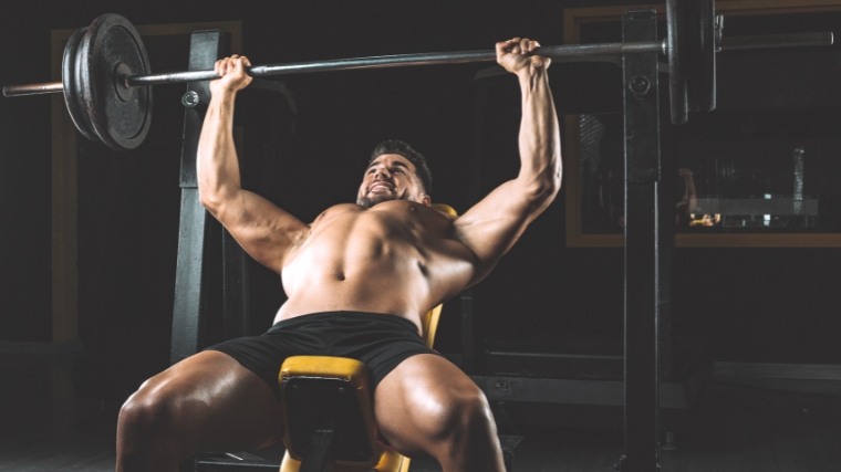 A person doing a barbell bench press.