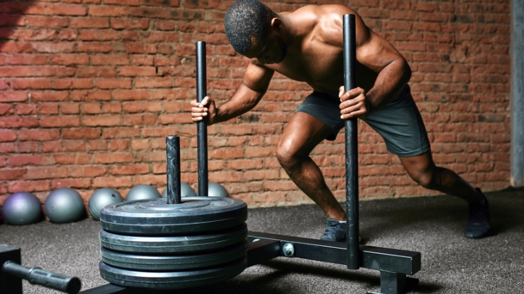 A person doing a sled push