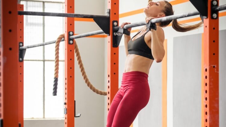 A person doing kipping pull-ups for a Crossfit fran.