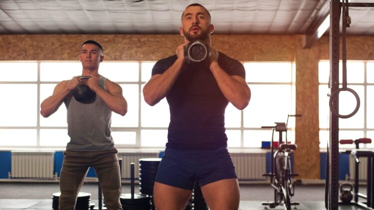 Athletes doing a goblet sumo squat.