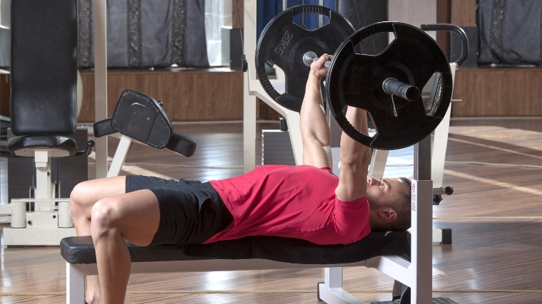 A person performing a barbell bench press.