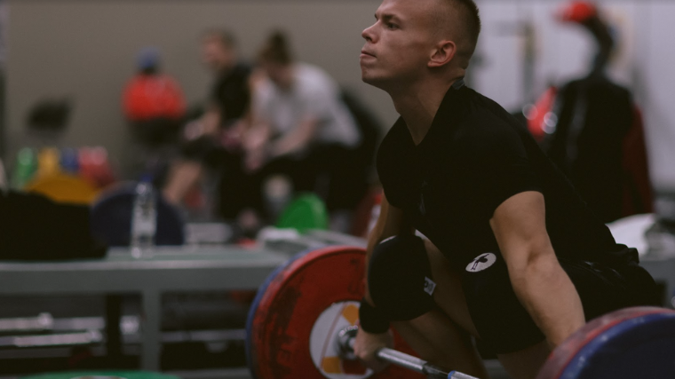 Weightlifter Ritvars Suharevs prepares for hang snatch in training hall