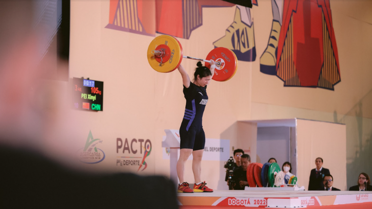 Weightlifter Pei Xinyi completes her snatch in competition