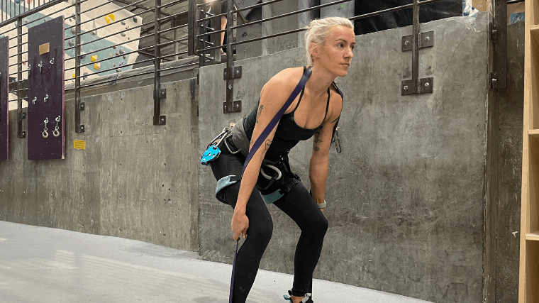 Woman does deadlifts with resistance band