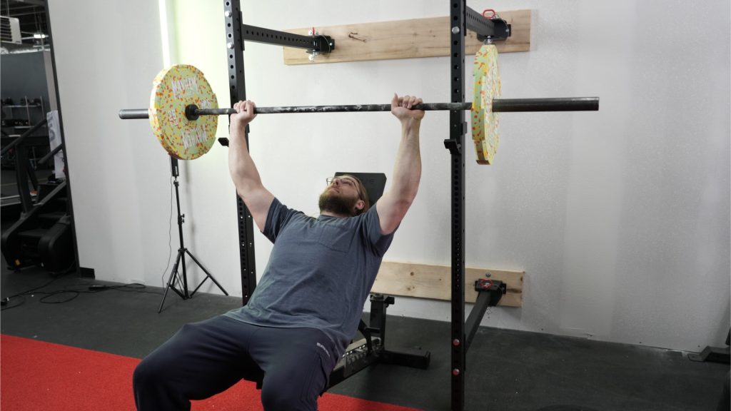 Person benching on Titan T3 folding rack