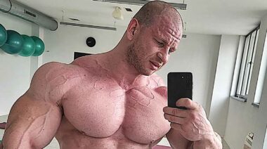 Bodybuilder Michal Krizo taking a shirtless mirror selfie.