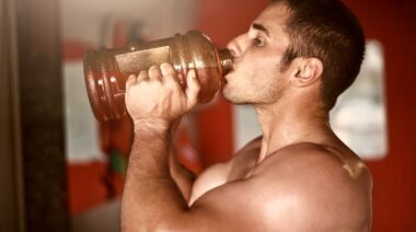 A person drinking before working out.